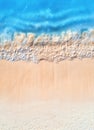 Aerial view of clear blue sea with waves and empty sandy beach Royalty Free Stock Photo