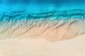 Aerial view of clear blue sea with waves and empty sandy beach Royalty Free Stock Photo