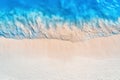 Aerial view of clear blue sea with waves and empty sandy beach Royalty Free Stock Photo