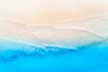 Aerial view of clear blue sea with waves and empty sandy beach Royalty Free Stock Photo