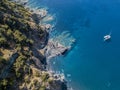 Aerial view of a cliff overlooking the sea and a moored catamaran, boat. Corsica. Coastline. France