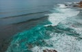 Aerial view of a cliff in the portuguese coastline with ocean waves and brown rocks Royalty Free Stock Photo