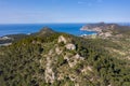 Aerial view of cliffs on top of mountain in Peguera, Mallorca, Spain. Blue sea and Es Camp de Mar in background