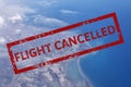 Aerial view of cloud, sea, ocean, city landscape from airplane with text flight cancelled. Flight cancellation due to impact of Royalty Free Stock Photo