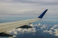 Aerial view of cloud and sky with airplane wing from window Royalty Free Stock Photo