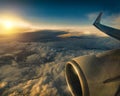 Aerial view of clouds at golden sunset seen from plane window Royalty Free Stock Photo