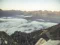 Aerial view of clouds under the mountains during sunset Royalty Free Stock Photo