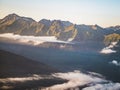 Aerial view of clouds under the mountains during sunset Royalty Free Stock Photo