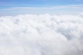 Aerial view of cloudscape from aircraft window show mass of soft white clouds and freshness tropical summer blue sky background