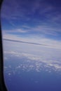 Aerial view on cloudy skies from airplane window Royalty Free Stock Photo