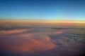 Aerial view of a cloudy sunset while flying above the clouds Royalty Free Stock Photo