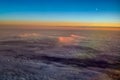 Aerial view of a cloudy sunset while flying above the clouds Royalty Free Stock Photo