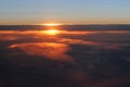 Aerial view of a cloudy sunset while flying above the clouds Royalty Free Stock Photo