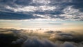 Aerial view of a cloudy sunset while flying above the clouds Royalty Free Stock Photo