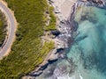 Aerial view of the coast of Corsica, winding roads and coves with crystalline sea. France Royalty Free Stock Photo