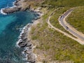 Aerial view of the coast of Corsica, winding roads and coves. Motorcyclists parked on the edge of a road. France Royalty Free Stock Photo