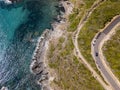 Aerial view of the coast of Corsica, winding roads and coves. Motorcyclists parked on the edge of a road. France Royalty Free Stock Photo