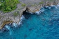 Aerial view of a coastal area with the rocks on the foamy beach