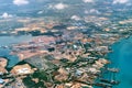 Aerial view of coastal construction or port areas in Strait of Malacca, on airplane route to Malaysia or Singapore