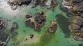 Aerial view of coastal landscape with cliffs and green water. Generative AI