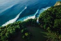 Aerial view of coastline with lighthouse and ocean with ideal blue waves in Uluwatu, Bali Royalty Free Stock Photo