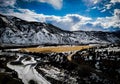 Aerial view of the Colorado River in winter, surrounded by snow-capped mountains and evergreen trees Royalty Free Stock Photo