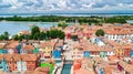 Aerial view of colorful Burano island houses in Venetian lagoon sea from above, Italy