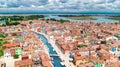 Aerial view of colorful Burano island in Venetian lagoon sea from above, Italy Royalty Free Stock Photo