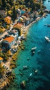 Aerial view of a colorful coastal village with turquoise waters and scattered boats along the Italian Riviera Royalty Free Stock Photo