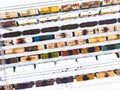 Aerial view of colorful freight train cars on the railway station. Wagons with goods on railroad. Industrial conceptual scene with Royalty Free Stock Photo