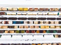 Aerial view of colorful freight train cars on the railway station. Wagons with goods on railroad. Industrial conceptual scene with Royalty Free Stock Photo