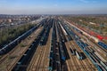 Aerial view of colorful freight trains on the railway station. Wagons with goods on railroad. Heavy industry. Industrial