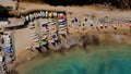 Aerial view of colorful kayaks and tourists on a sandy beach