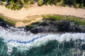 Aerial view of a colorful seashore with large waves Royalty Free Stock Photo