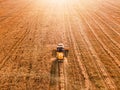 Aerial view of Combine harvester agriculture machine harvesting golden wheat field Royalty Free Stock Photo