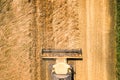 Aerial view of combine harvester harvesting large ripe wheat field. Agriculture from drone view Royalty Free Stock Photo