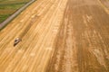 Aerial view of combine harvester harvesting large ripe wheat field. Agriculture from drone view Royalty Free Stock Photo