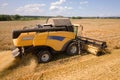 Aerial view of combine harvester harvesting large ripe wheat field. Agriculture from drone view Royalty Free Stock Photo