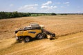 Aerial view of combine harvester harvesting large ripe wheat field. Agriculture from drone view Royalty Free Stock Photo