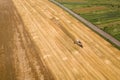 Aerial view of combine harvester harvesting large ripe wheat field. Agriculture from drone view Royalty Free Stock Photo