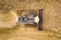 Aerial view of combine harvester harvesting large ripe wheat field. Agriculture from drone view Royalty Free Stock Photo