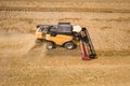 Aerial view of combine harvester harvesting large ripe wheat field. Agriculture from drone view Royalty Free Stock Photo