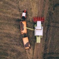 Aerial view of combine pouring harvested corn grains into traile Royalty Free Stock Photo