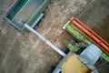 Aerial view of combine harvester unloading grain in cargo trailer working during harvesting season on large ripe wheat Royalty Free Stock Photo