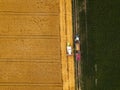 Aerial view of combine harvester unloading harvested wheat Royalty Free Stock Photo