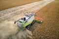 Aerial view of combine harvester working during harvesting season on large ripe wheat field. Agriculture concept Royalty Free Stock Photo