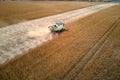 Aerial view of combine harvester working during harvesting season on large ripe wheat field. Agriculture concept Royalty Free Stock Photo