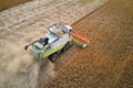 Aerial view of combine harvester working during harvesting season on large ripe wheat field. Agriculture concept Royalty Free Stock Photo