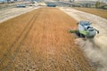 Aerial view of combine harvester working during harvesting season on large ripe wheat field. Agriculture concept Royalty Free Stock Photo