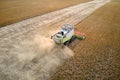 Aerial view of combine harvester working during harvesting season on large ripe wheat field. Agriculture concept Royalty Free Stock Photo